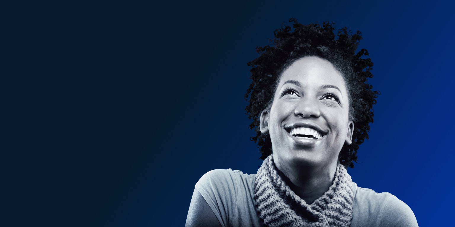a Black woman smiling and looking upward