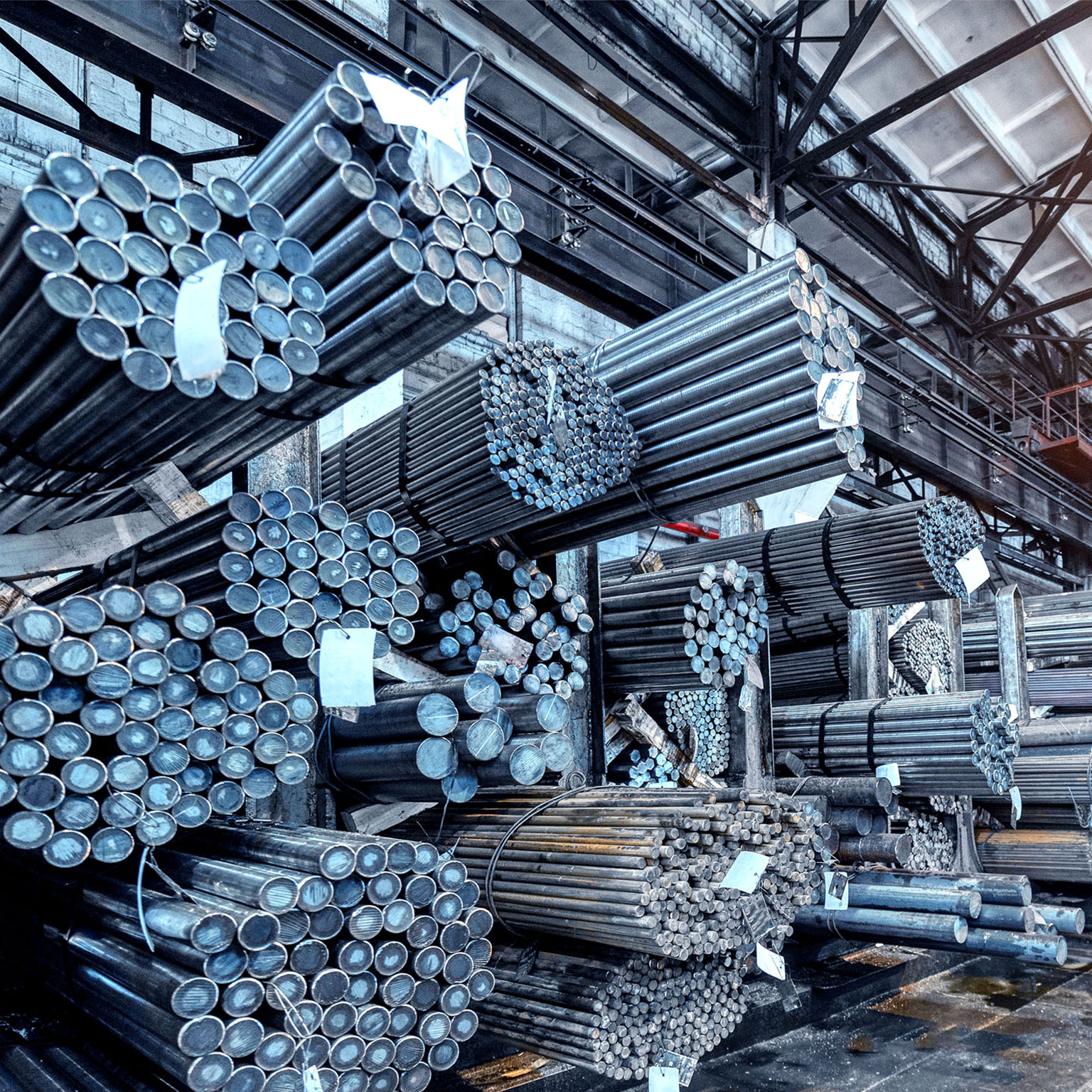 Rolled metal warehouse. Many packs of metal bars on the shelves