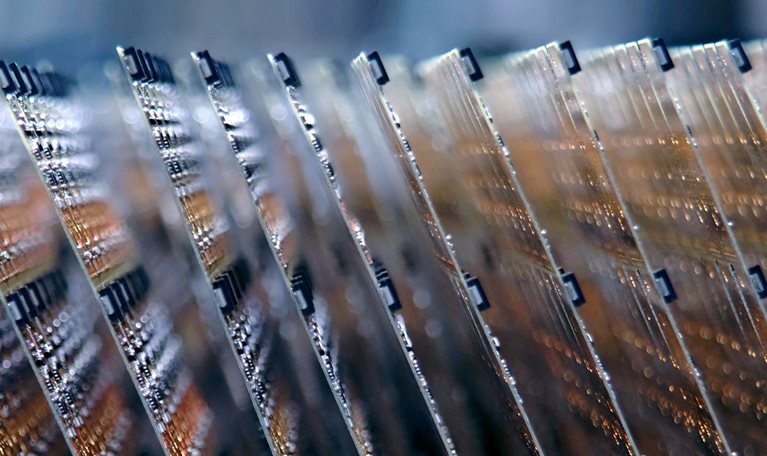 Electronic circuit boards stacked on an assembly line