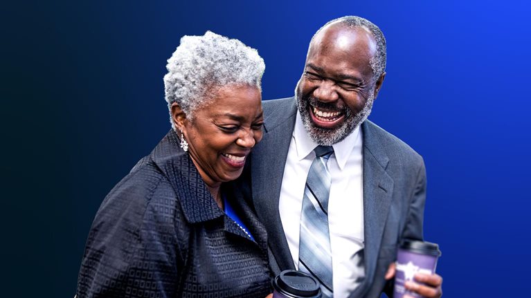 Elderly Black man and woman holding hot beverage tumblers